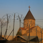 Armenian church behind barbed wire Baghdad, Iraq. (Photo: homocosmicos / Bigstock)